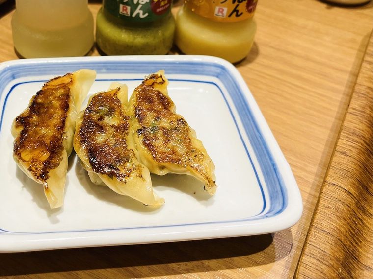 青い縁取りの白い小皿にのったリンガーハットの餃子3コ