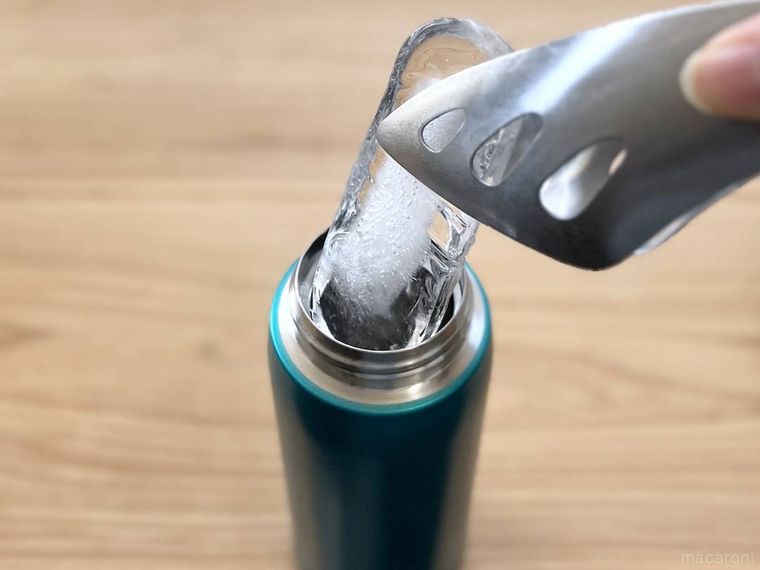棒状の氷を飲料ボトルに入れている様子
