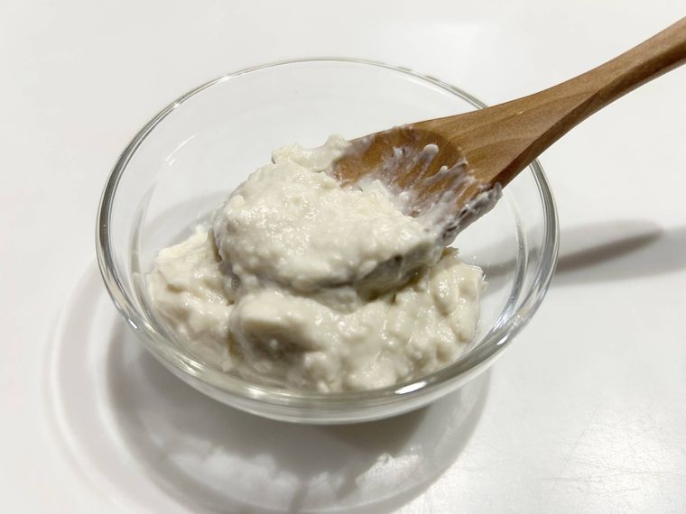手作りした酒かすパックをスプーンですくっている様子