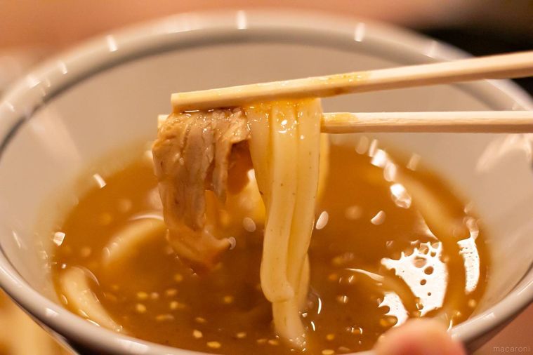 丸亀製麺濃厚魚介豚つけ汁うどんを箸上げしている