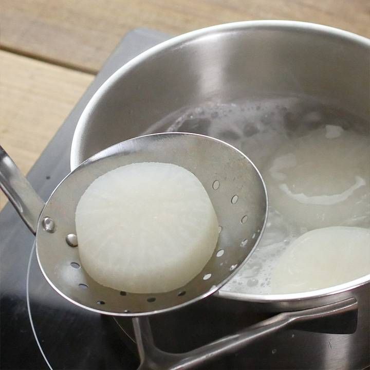 下ゆでした大根を鍋から出す様子