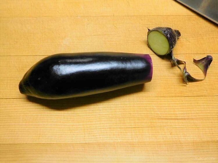 まな板の上でヘタを切り取ったナス