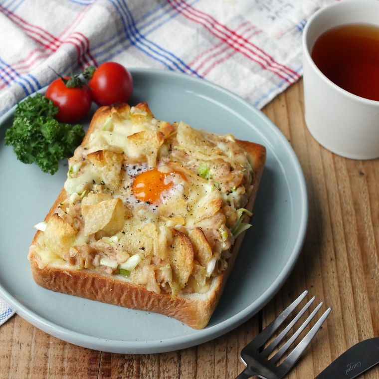 トースターで作ったポテトチップスやツナ、卵、とろけるチーズが具材のトーストが青い皿に盛り付けられているところ
