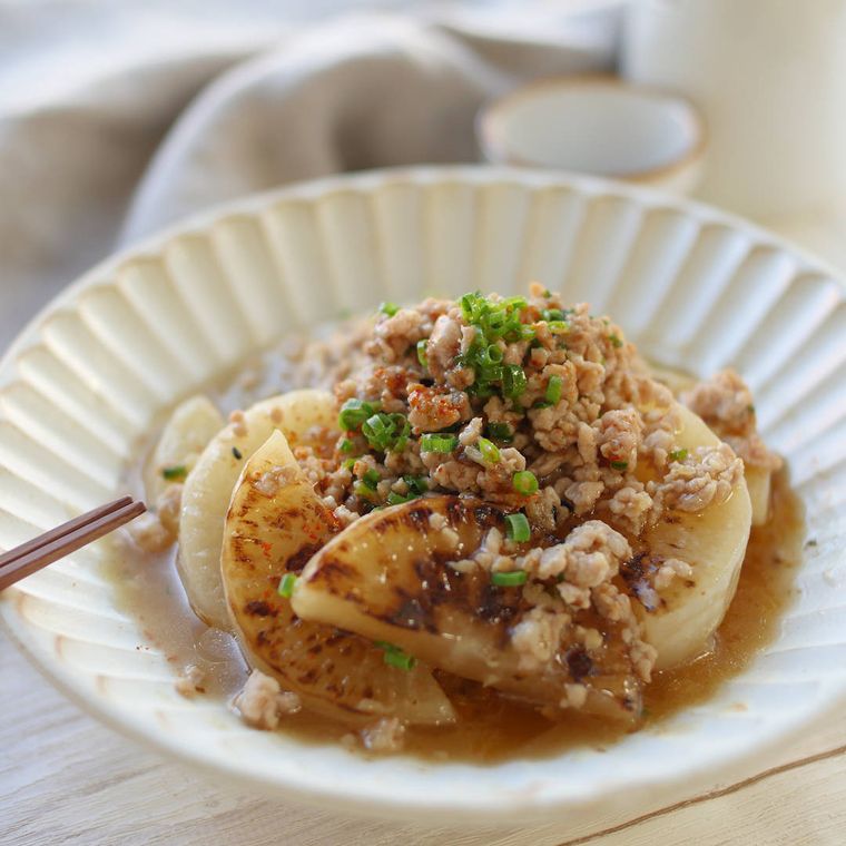 皿に盛り付けられた鶏ひき肉と焼き大根のあんかけ