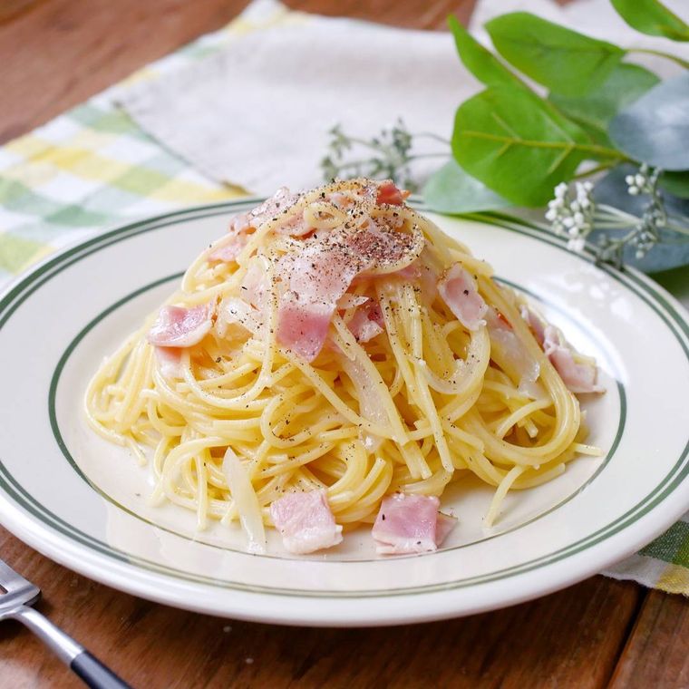 白い丸皿にレンジでペペロンチーノが盛られている