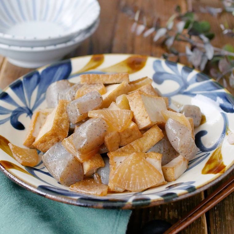 青と茶色の模様の皿に盛りつけられた大根とこんにゃくと厚揚げの甘辛炒め