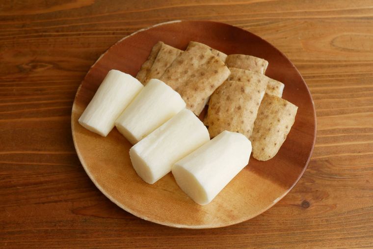 皮をむいた長芋と長芋の皮が木製の皿に盛られている