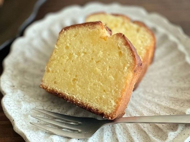 白色の皿に盛られた2切れのレモンパウンドケーキ