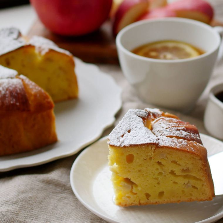 白い皿に取り分けられたさつまいもとりんごのケーキとレモンティー