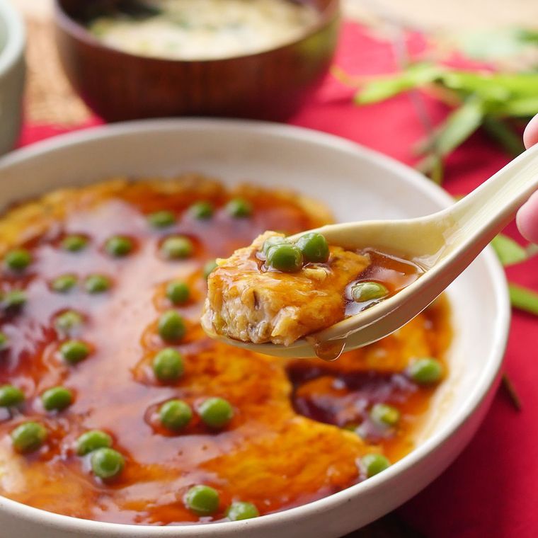 白い器に入ったかに玉を、白いレンゲですくっている様子