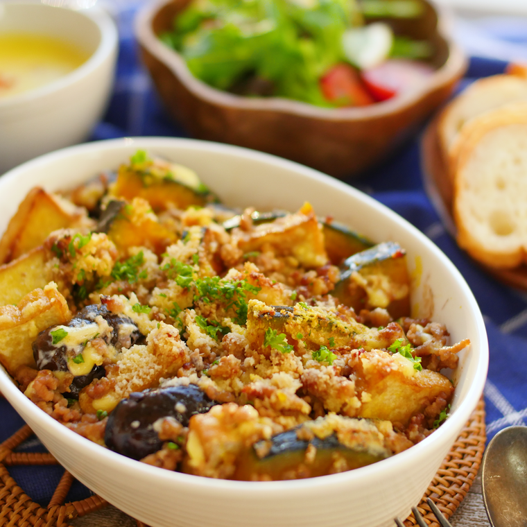 白い器に盛られたかぼちゃと焼きなすの肉みそグラタン