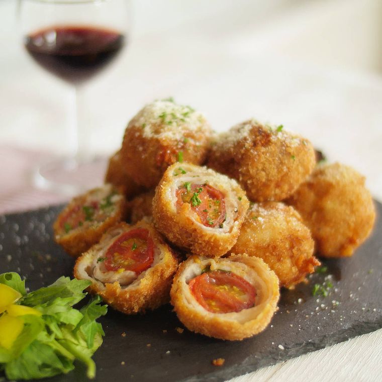 黒い皿に盛りつけられたひとくちマルゲリータかつ