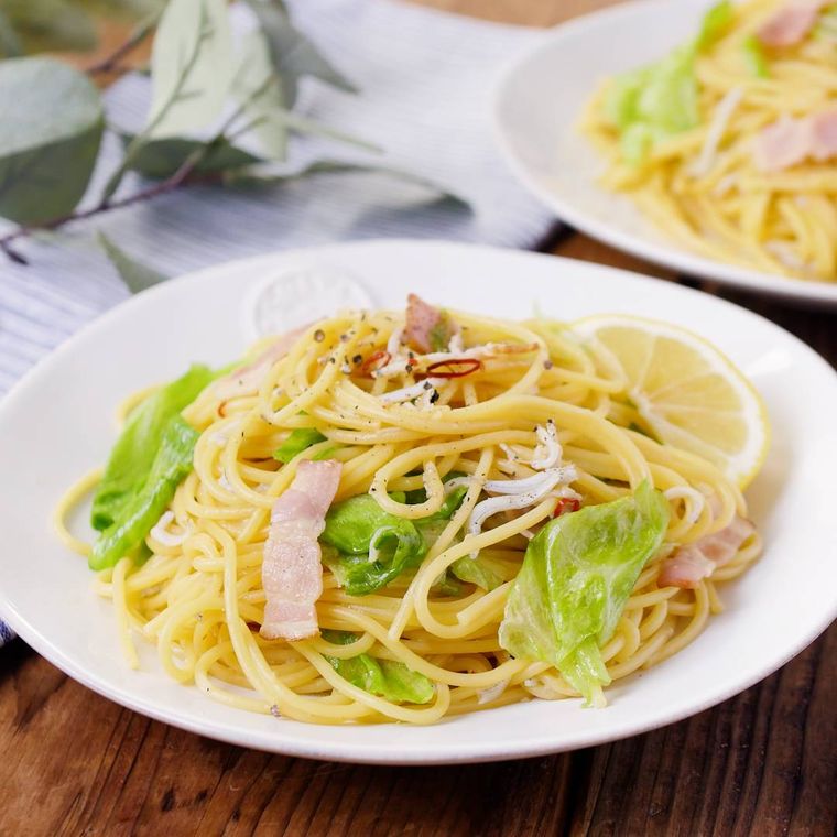 白い皿に盛り付けたレタスとベーコンのパスタ