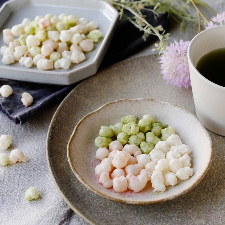 ベージュの丸い皿に入っている3色のひなあられ