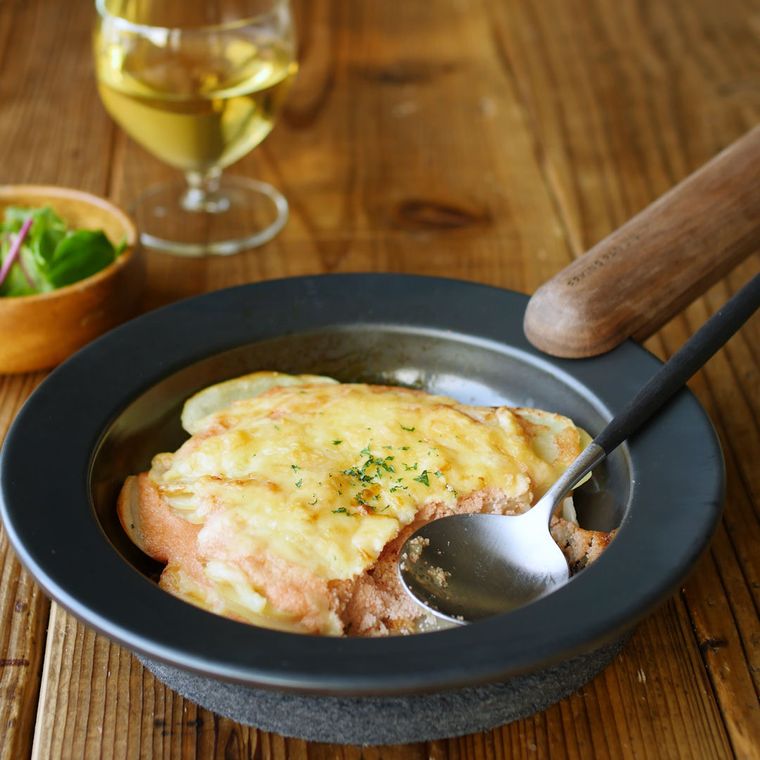 黒い耐熱皿に盛り付けた明太マヨソースのポテトグラタン