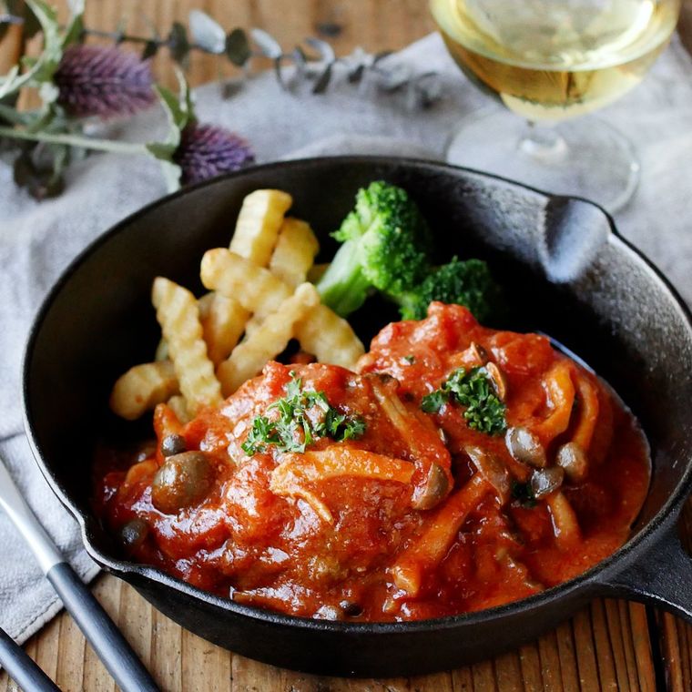 黒い器に盛られたトマトみその煮込みハンバーグ