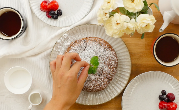 白い丸皿に盛られたガトーショコラにミントを飾る様子