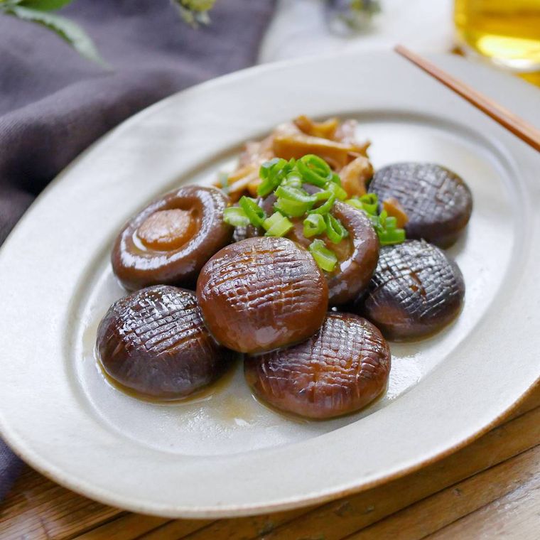 白い皿にのったまるごとしいたけのバターポン酢しょうゆ炒め