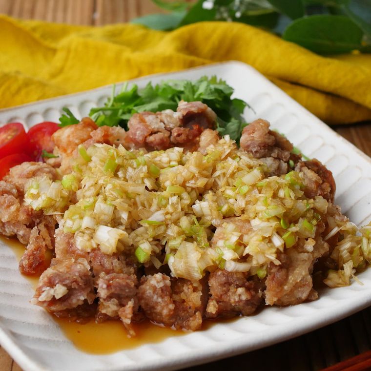 白い四角の皿に盛りつけられた香味ダレの油淋鶏