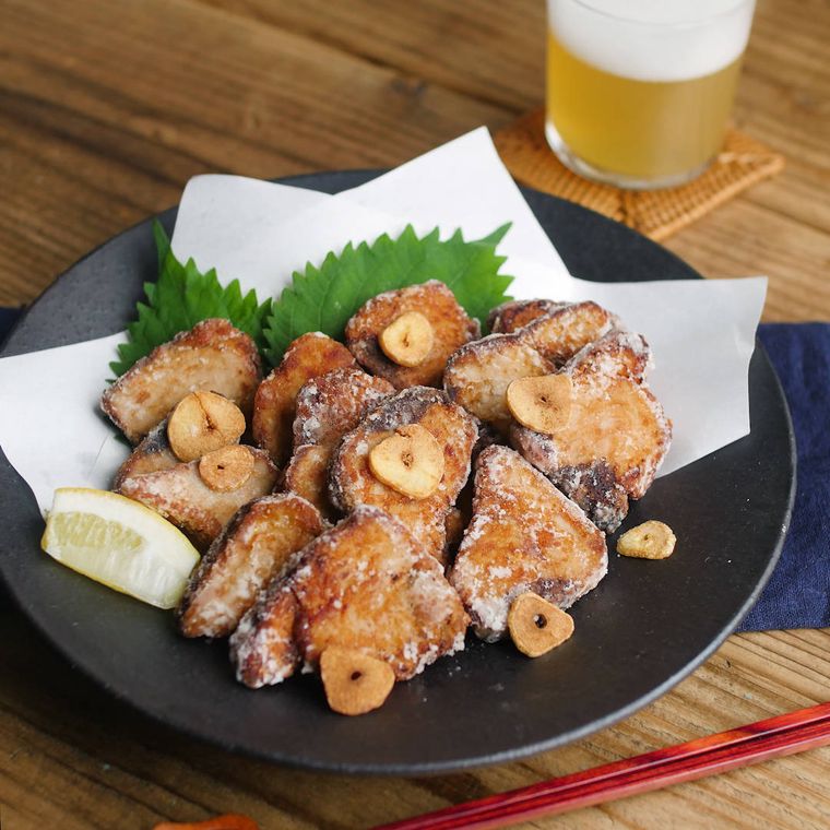 黒い皿に盛り付けたかつおのスタミナ竜田揚げ