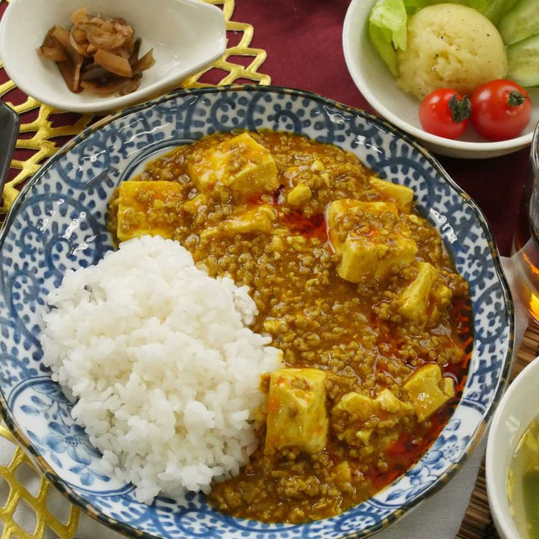 青い模様の入った皿に盛り付けられたピリピリマーボーカレー