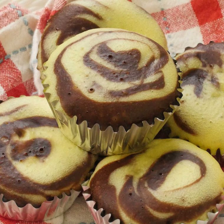 チェック柄の布の上に並べた、マーブルカップケーキ