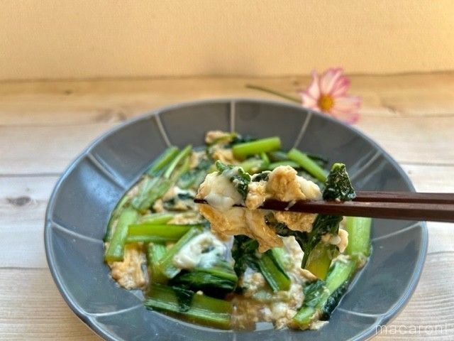 グレーの皿に入った小松菜の卵とじを箸あげしている様子