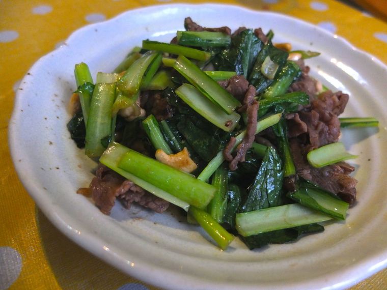 白い皿に盛り付けられた小松菜と牛肉の炒め物