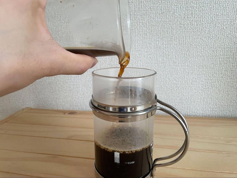 サーバーからコップに注がれるコーヒー