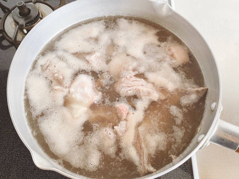 鍋で牛すじ肉をゆでる様子