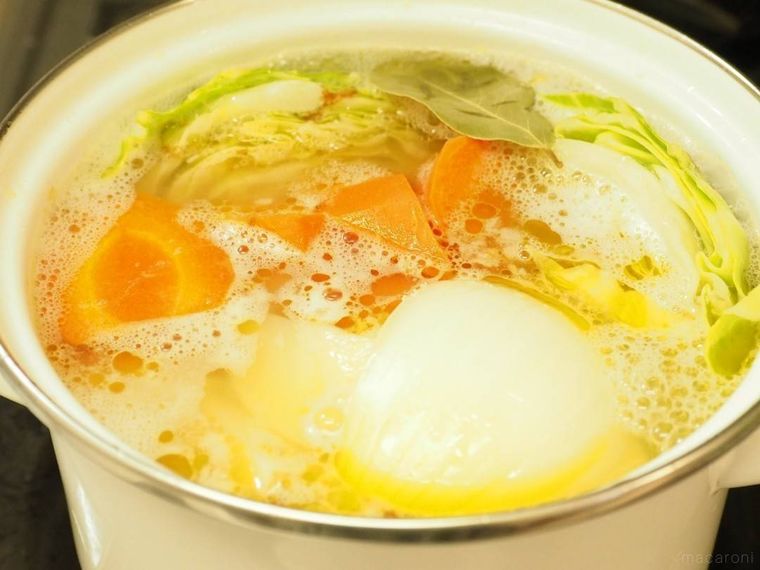 白いホーロー鍋に入ったポトフの野菜とスープ