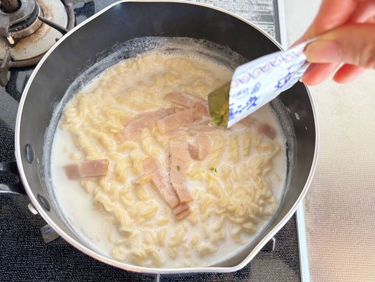 鍋に付属の粉末スープを入れる様子