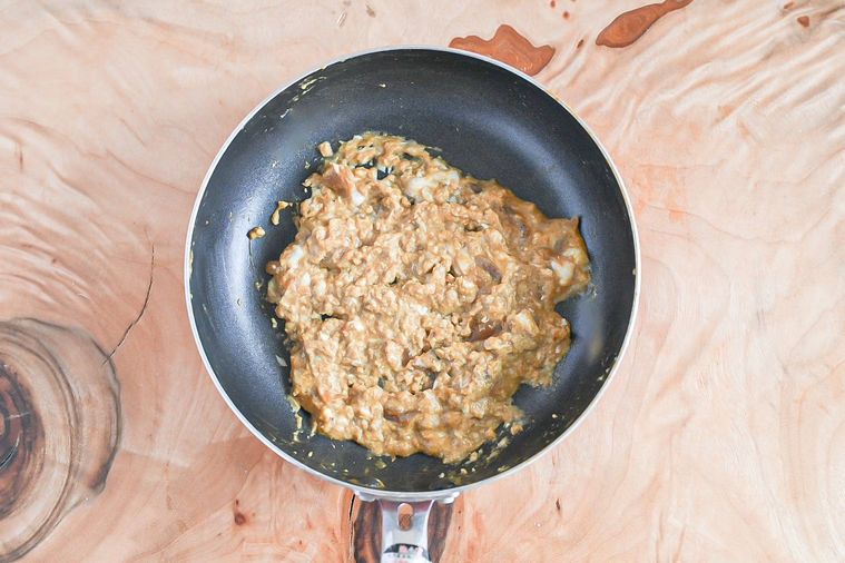 フライパンに入った卵ととろけるチーズを加えたカレー