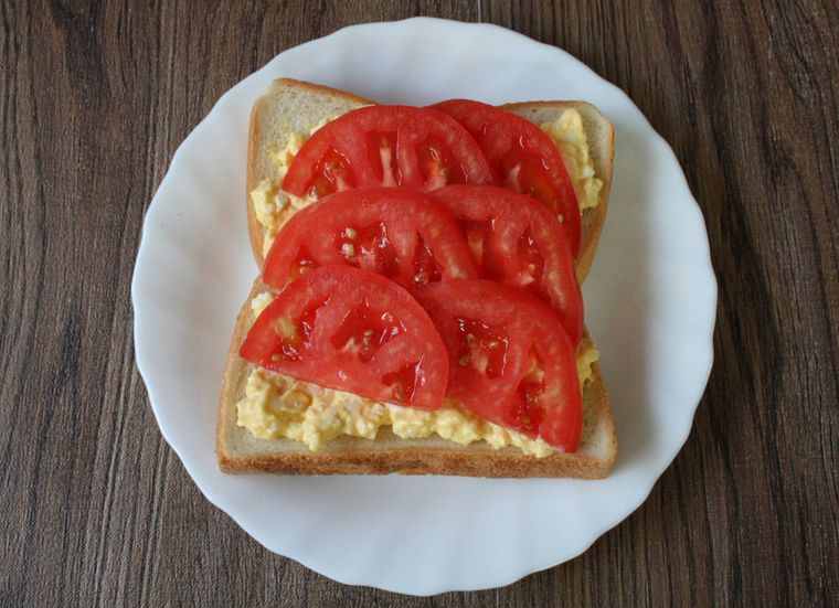 食パンの上に卵のフィリングとトマトをのせた様子