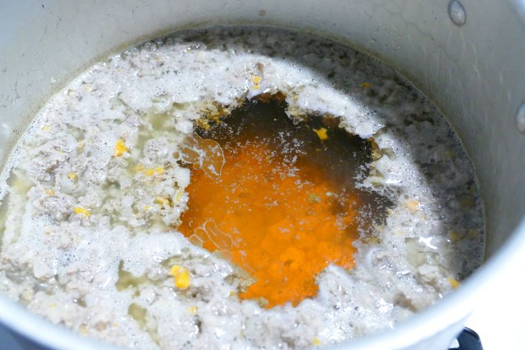 弱火でコンソメスープを煮る様子