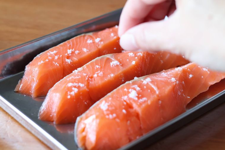 鮭に塩をふっている