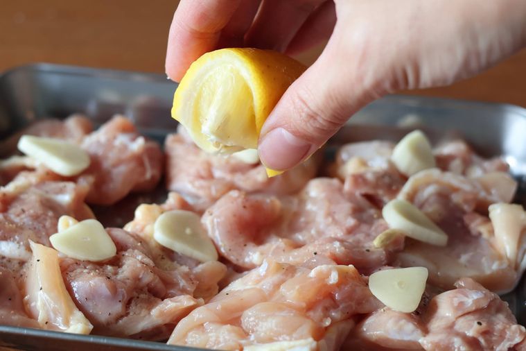 鶏肉とにんにくにレモンを絞っている