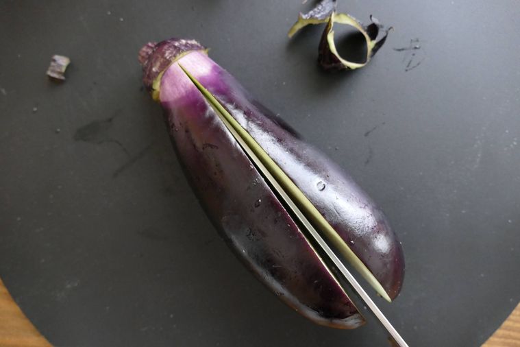 なすのヘタを残して縦半分に切り込みを入れた様子