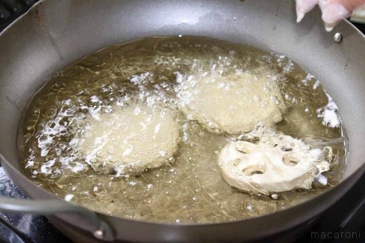 天ぷら鍋に衣をつけたれんこんを入れている様子