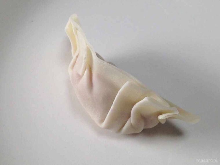 ひだのない裏側を少しくぼませ、三日月形に整えた様子