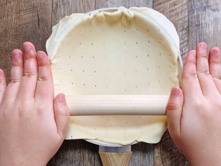 フライパンの上で麺棒を転がしている様子