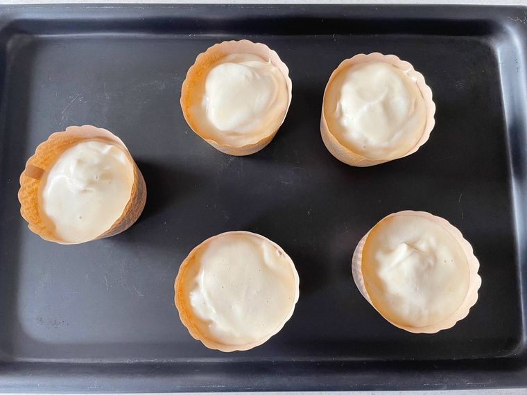 天板におかれたシフォンケーキ生地が入ったマフィンカップ