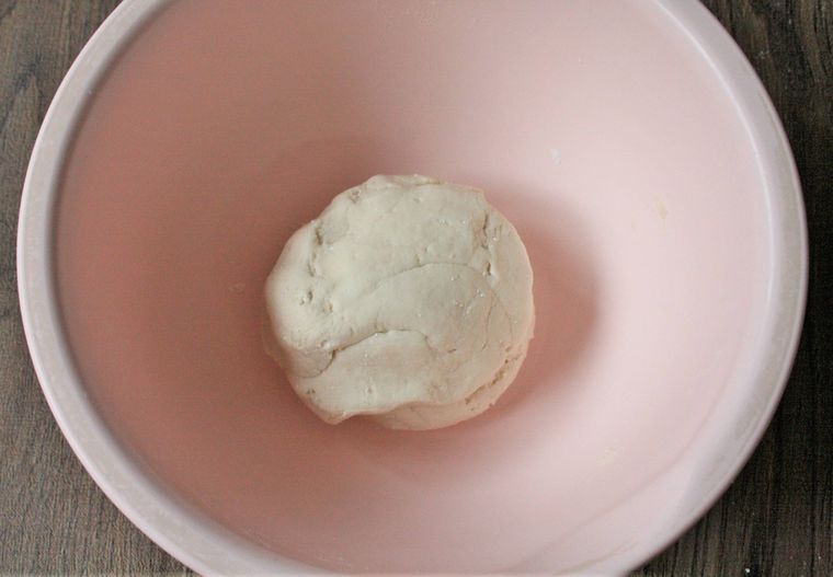 ピンク色のボウルで生地をひとまとまりにした様子