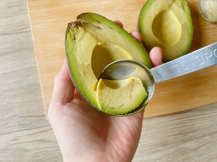 スプーンでアボカドをすくう様子
