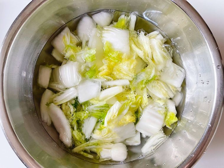 塩揉みした白菜を水で洗う様子
