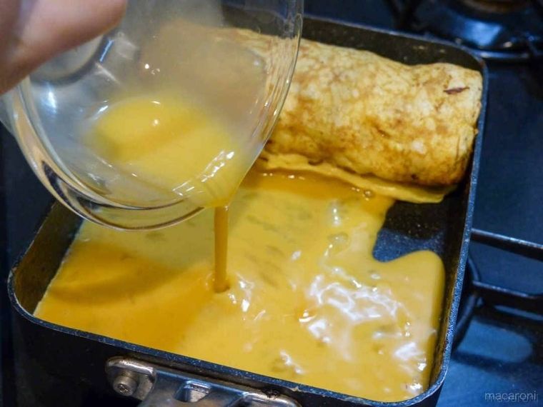 卵焼き用フライパンに卵を流し入れているところ