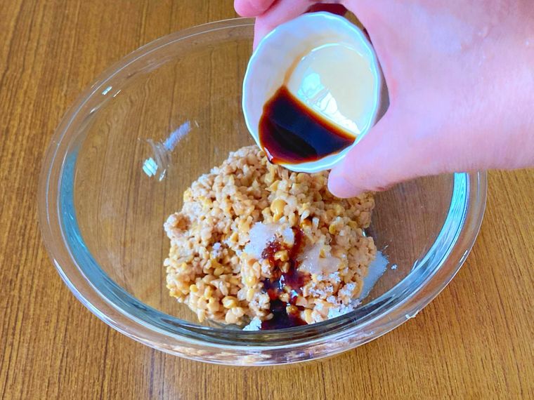 ボウルにひきわり納豆と調味料を入れている様子