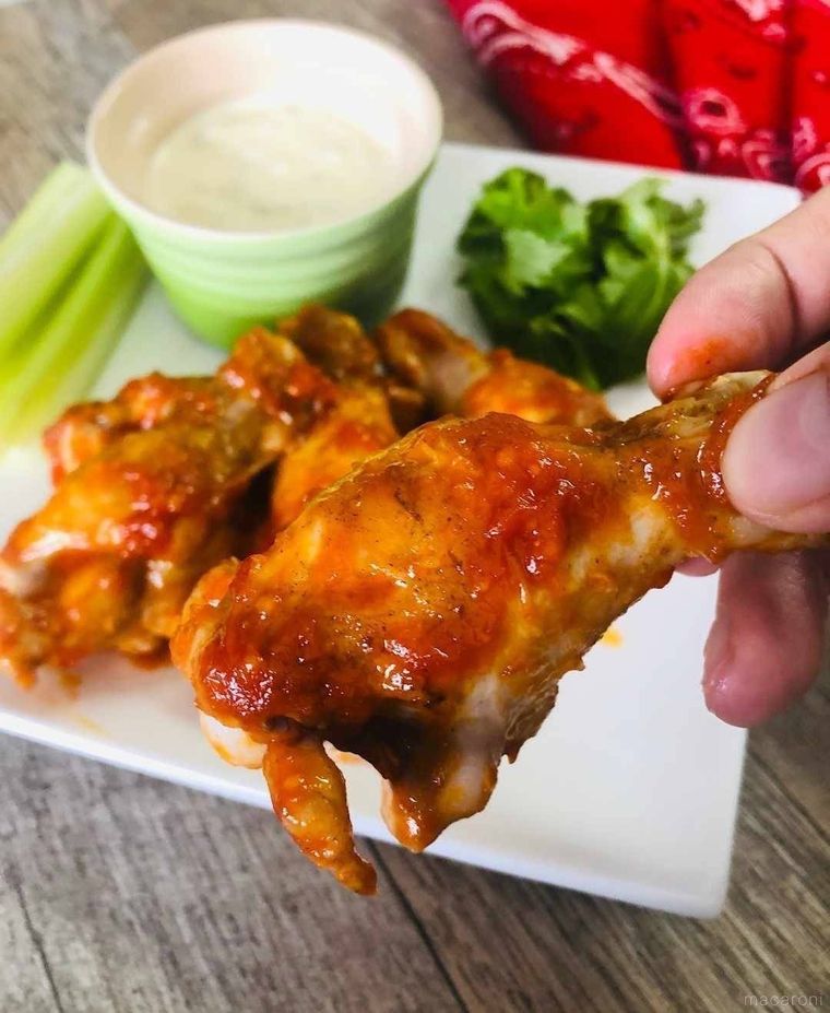 バッファローウィングを手でつかんでいる様子