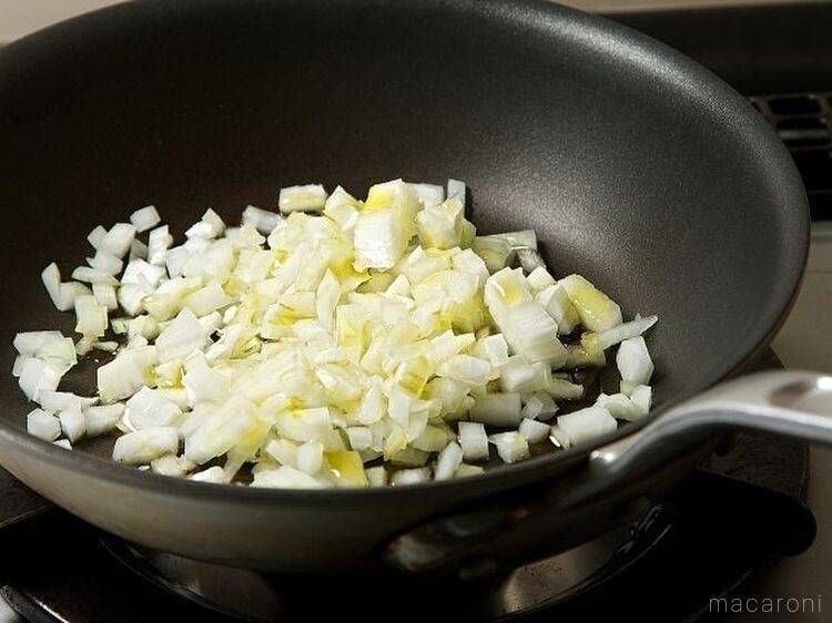 黒いフライパンで玉ねぎを加熱している様子