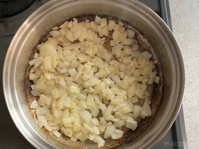 みじん切りの玉ねぎを、鍋で炒めている様子